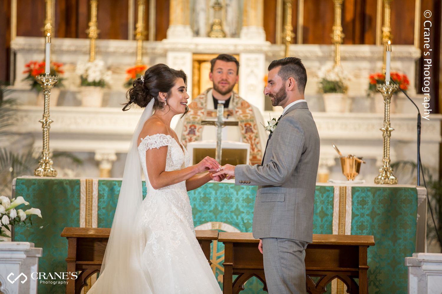 Lisa and Joe exchange rings at the altar of St. Peter and Paul Church in Naperville