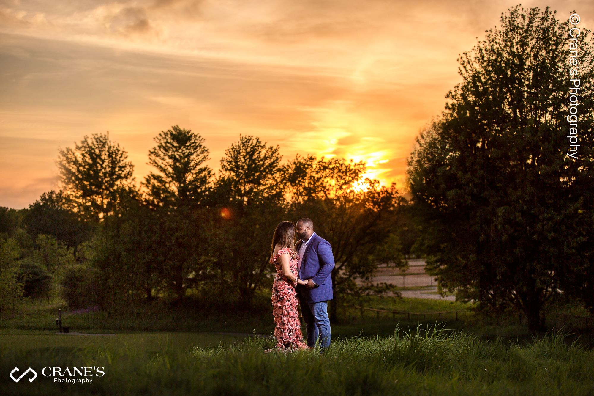 A romantic engagement session photo of a couple at Cantigny Park during sunset time.