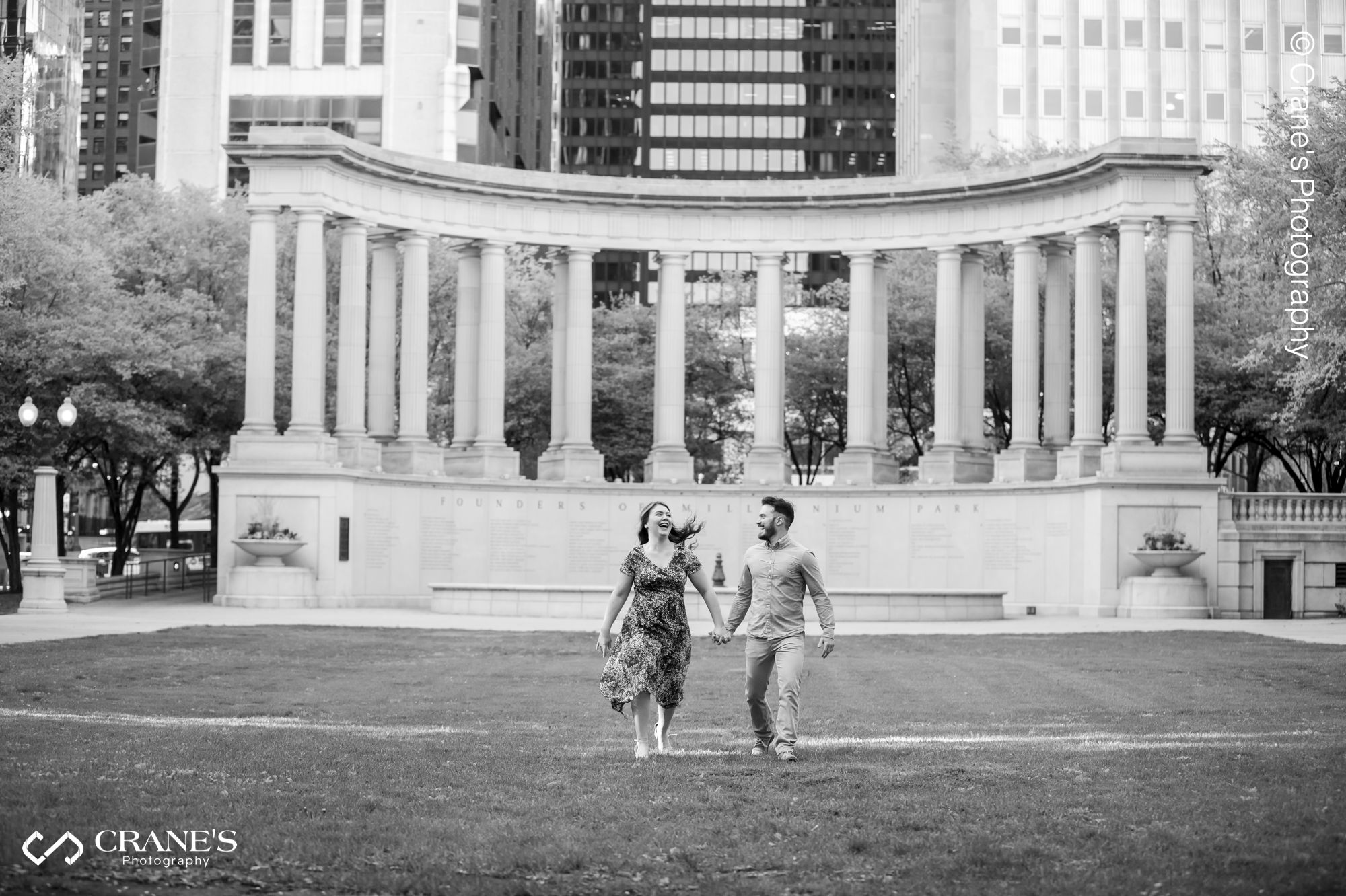 Action image of an engaged couple at Millennium Park