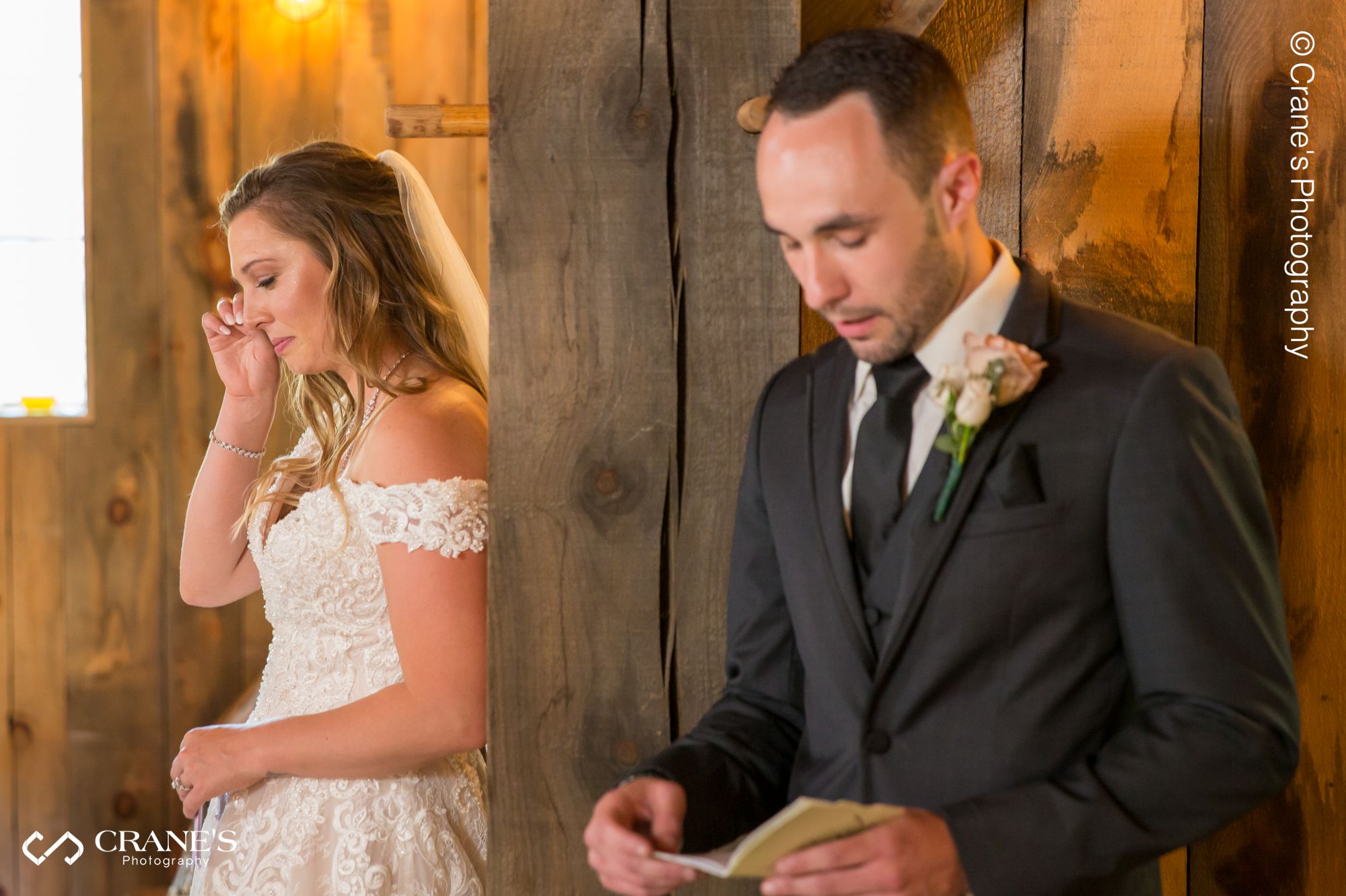 Bride and groom read their vows in private before their wedding ceremony at The Swan Barn Door in Wisconsin Dells.