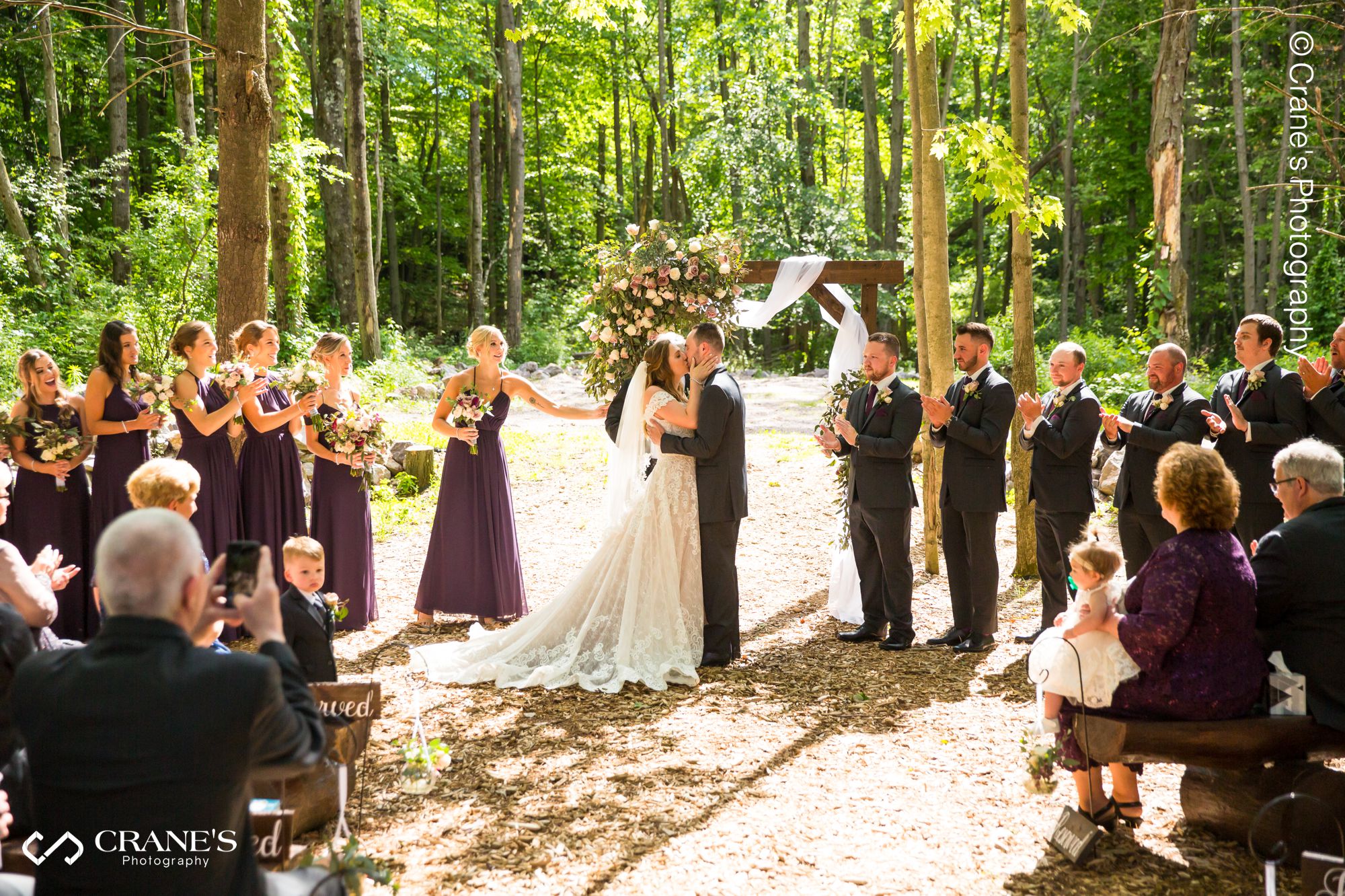 Bride and groom's first kiss as husband and wife at the wedding at The Swan Barn Door