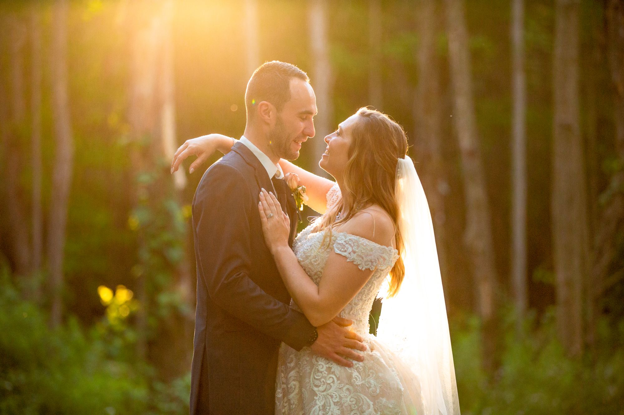 A bride and groom pose of a photo during the golden hour at their The Swan Barn Door wedding