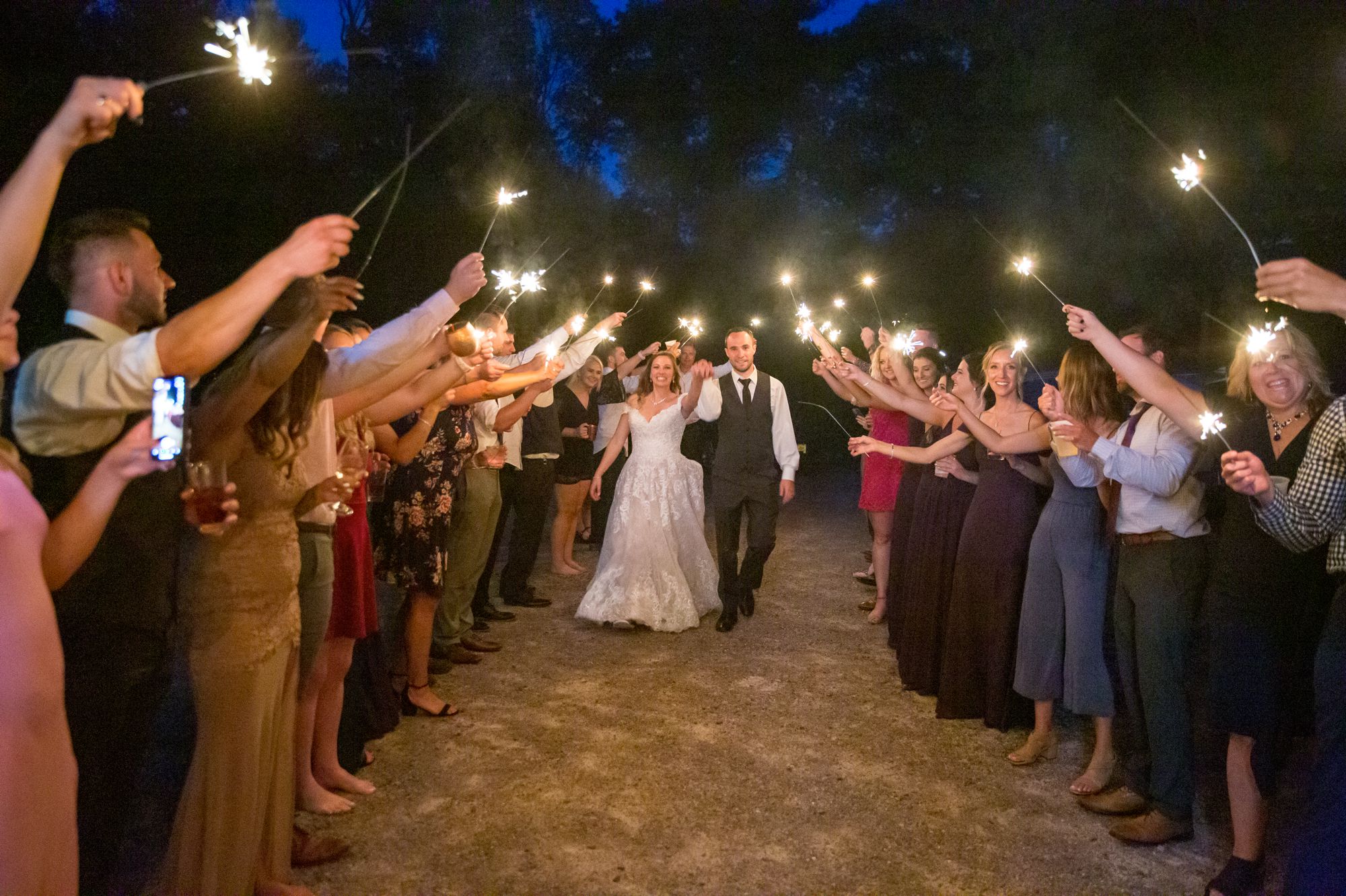 Bride and groom walk during their sparklers send-off ceremony