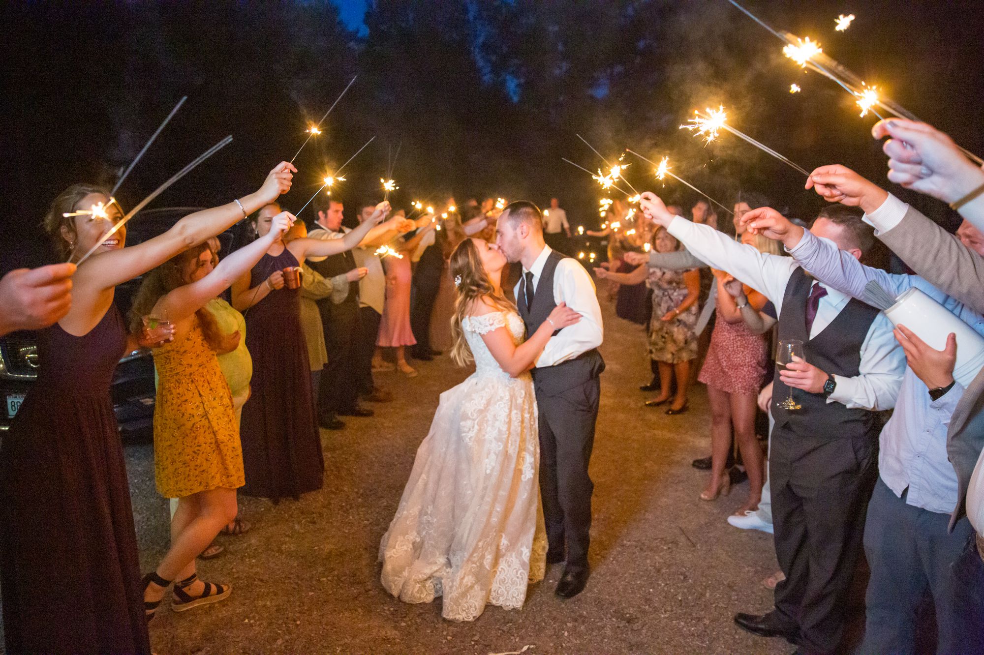 Bride and groom kiss at a sparklers sent-off ceremony at The Swan Barn Door in Wisconsin Dells