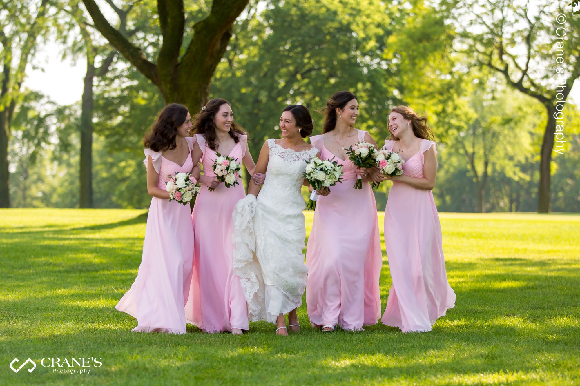 A candid photo of a wedding party walking at La Grange Country Club