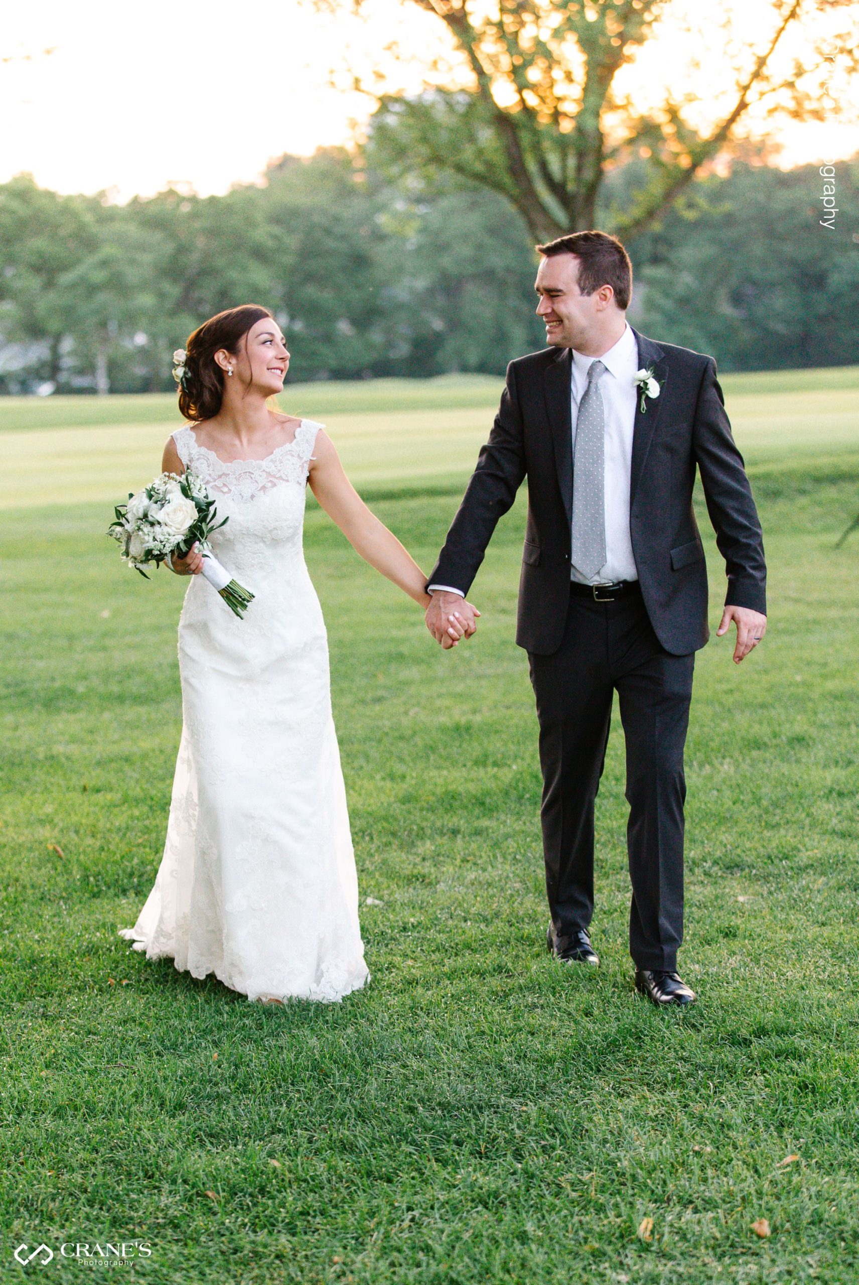 Bride and groom walking during the golden hour at La Grange Country Club