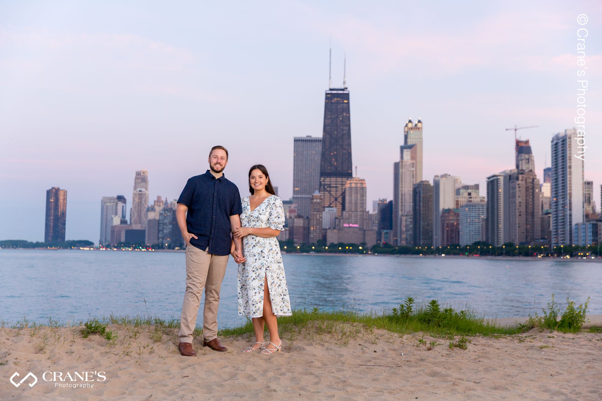 An engagement session photo with a view of Downtown Chicago from Lincoln Park