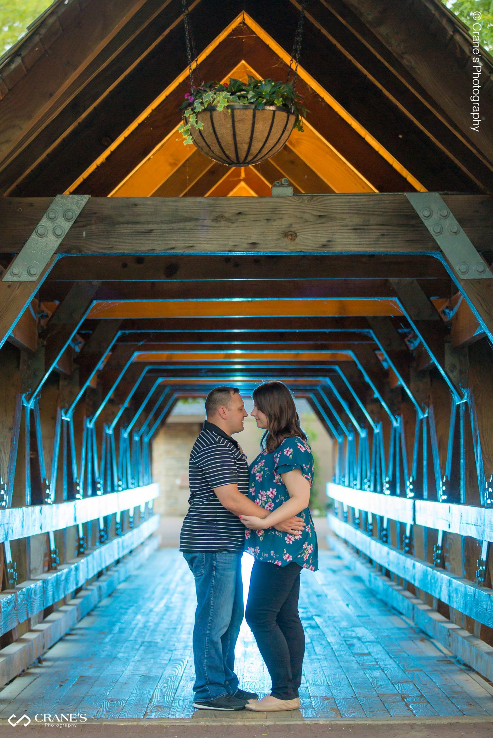 A backlit photo of couple at Naperville Riverwalk at their engagement session