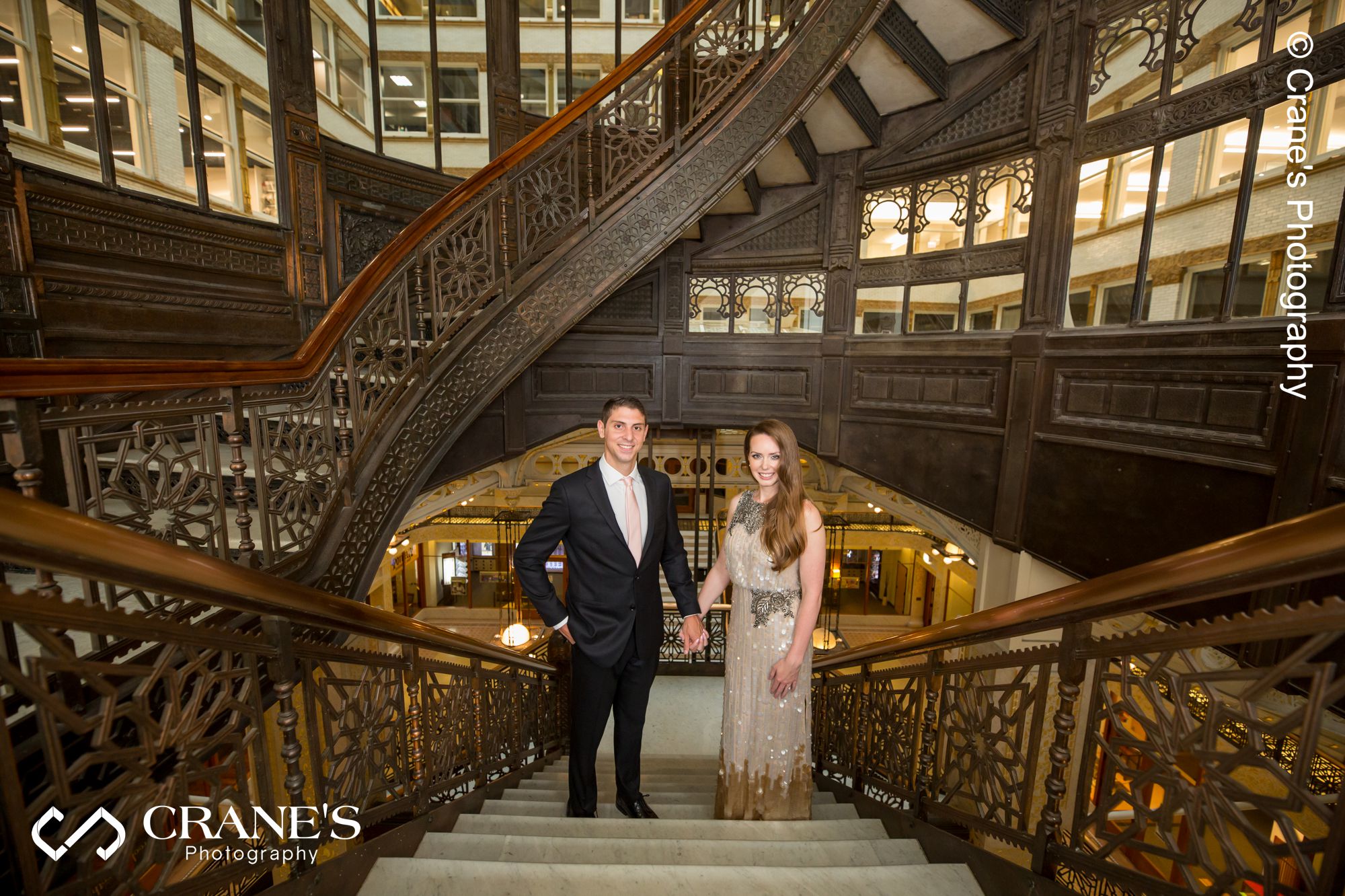 Timeless image of a couple standing at the stairs at The Rookery Building in Chicago
