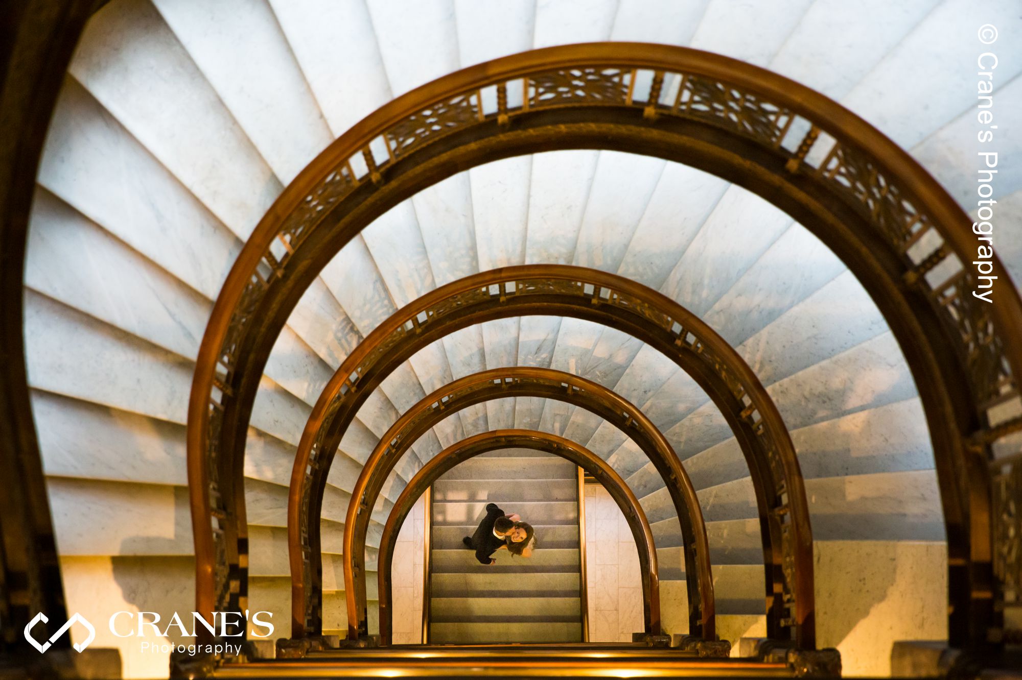 The spiral staircase at the Rookery in Chicago engagement photo