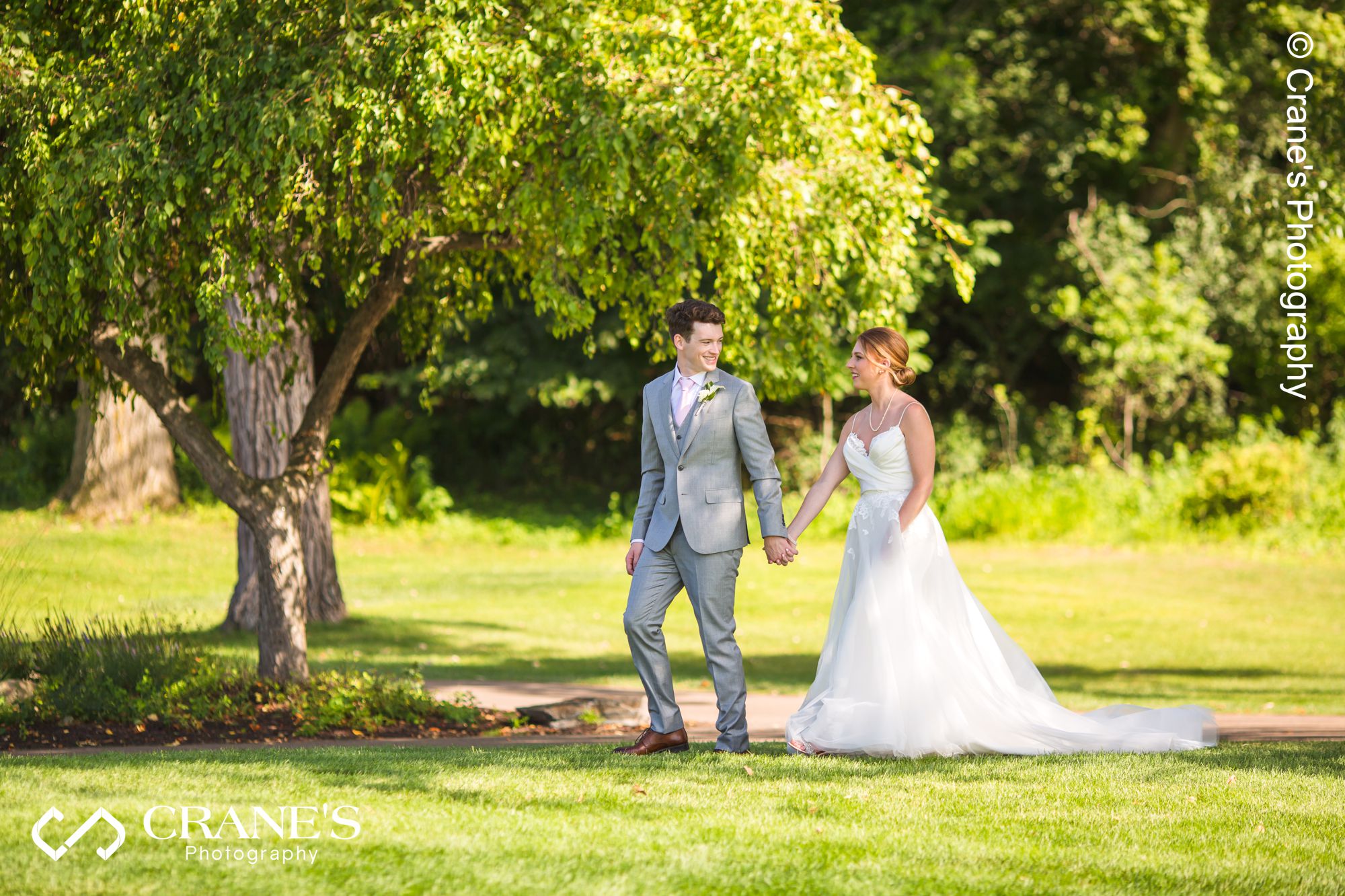 Bride and groom walking hand in hand at Big Foot Country Club