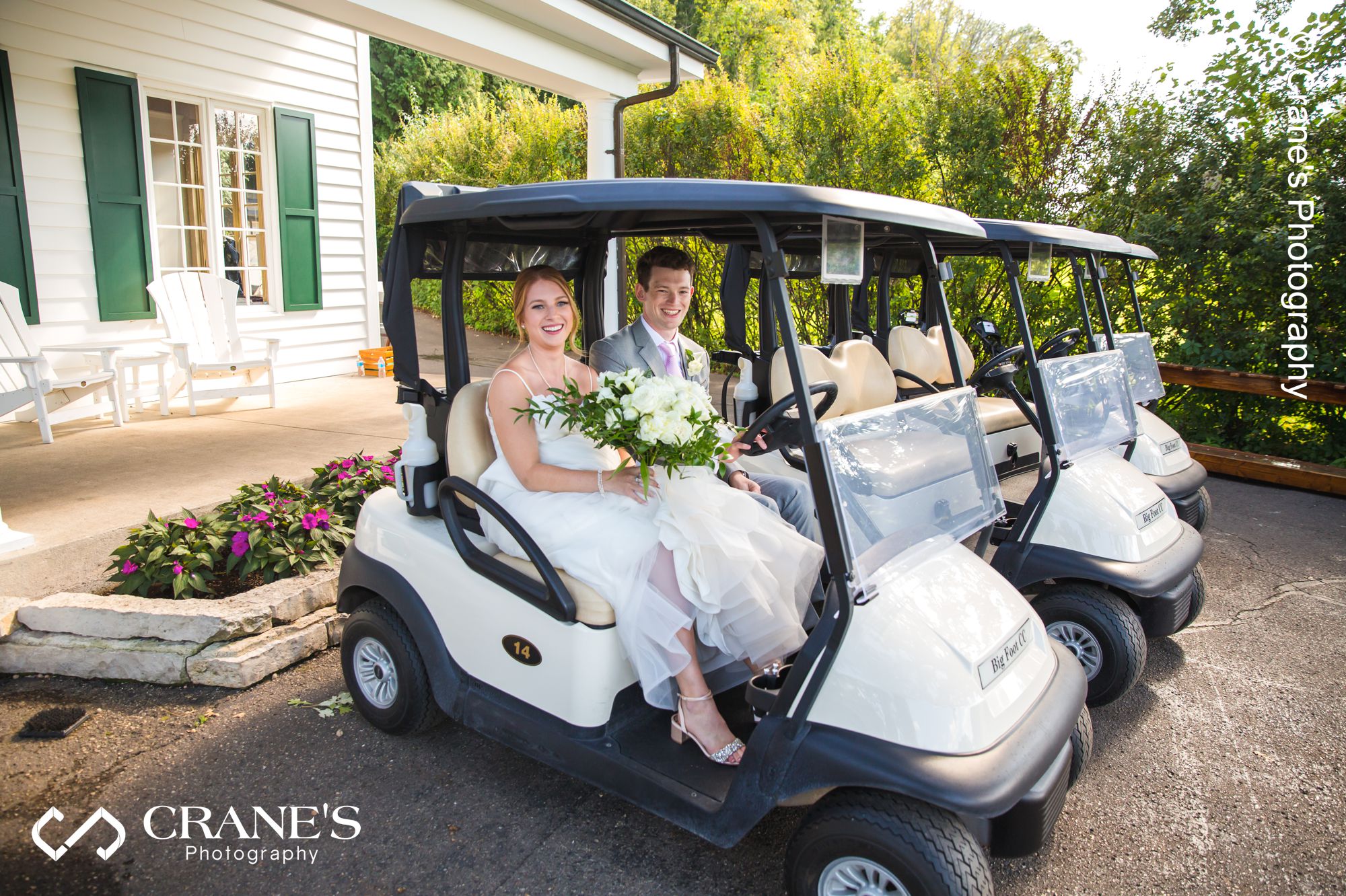 Bride and groom on a golf cart at Big Foot Country Club