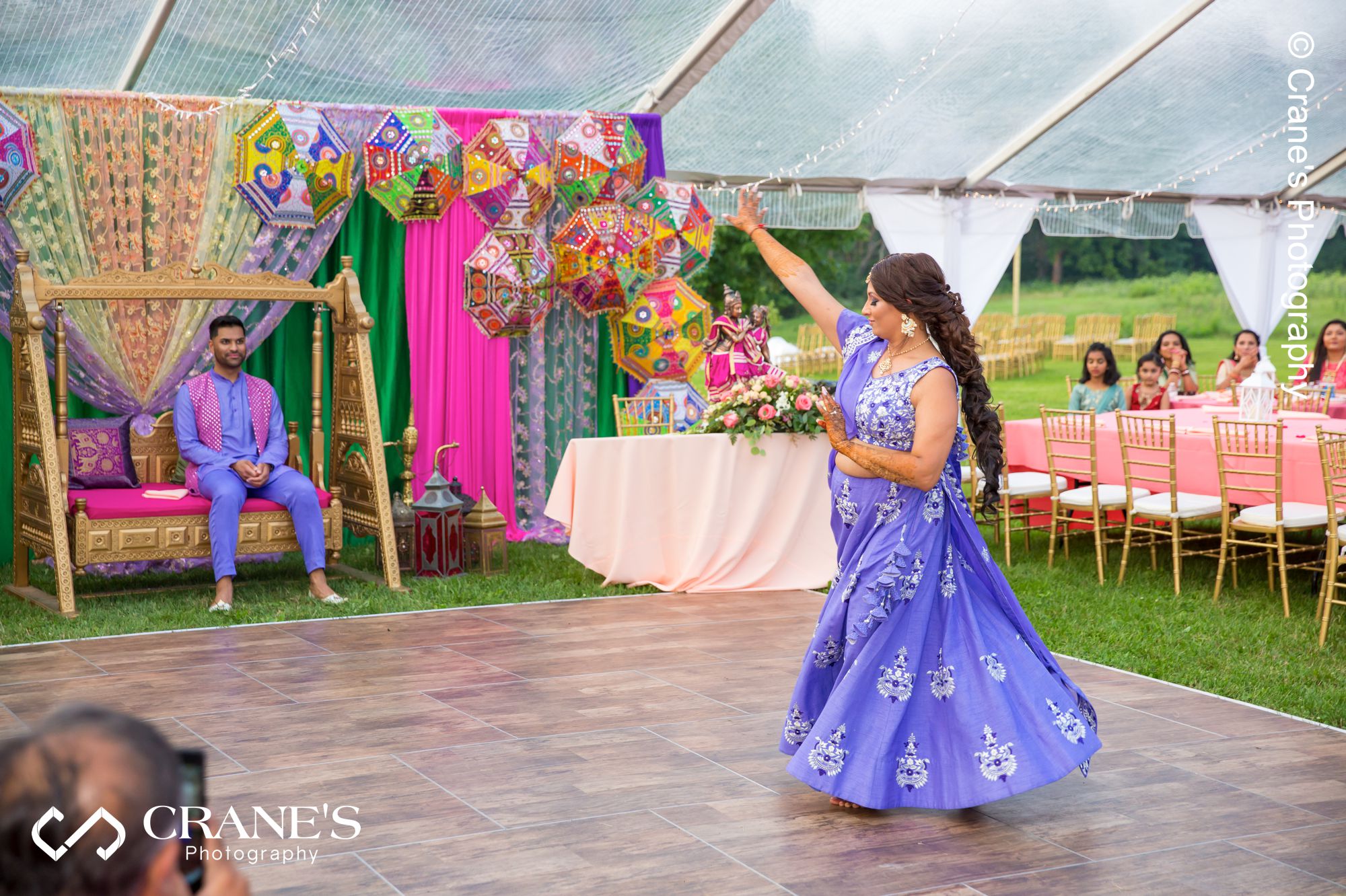 An Indian bride perform a traditional dance for her groom at their Sangeet