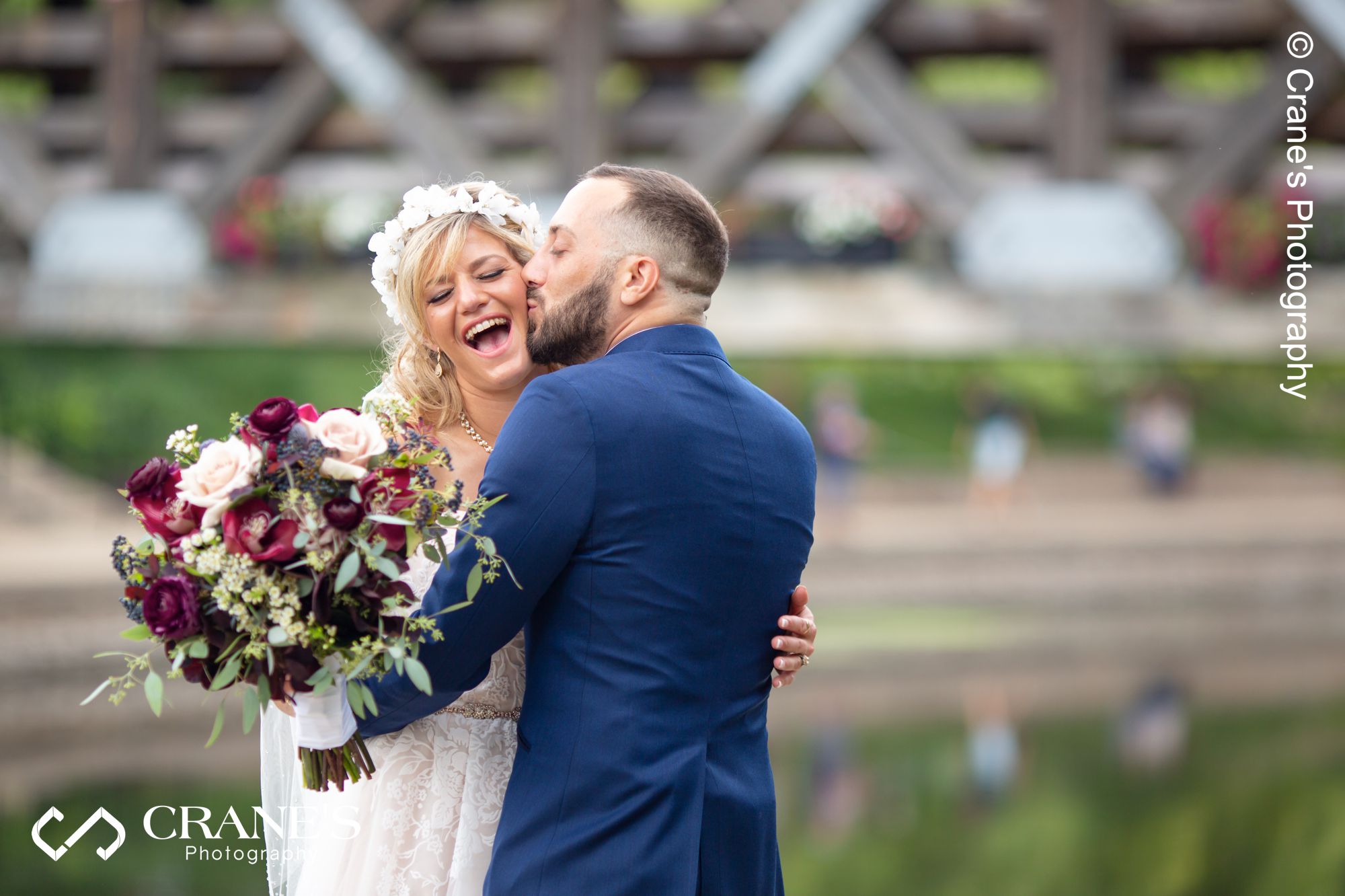 A candid wedding portrait taken by the river outside the Elements at Water Street in Naperville
