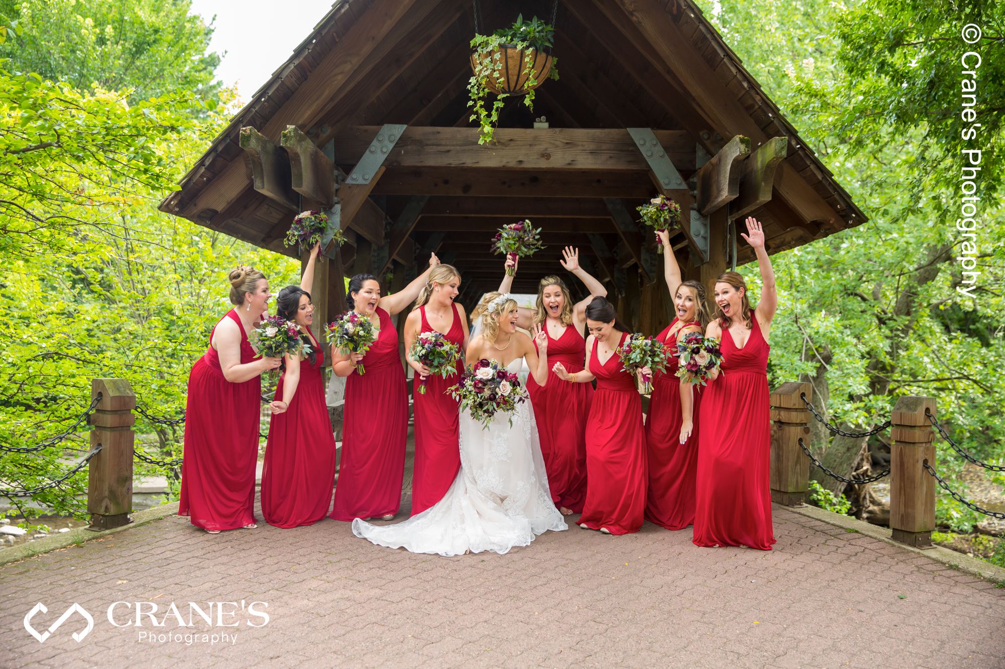 A candid bridal party wedding photo taken in front of the wooden bride at Naperville Riverwalk