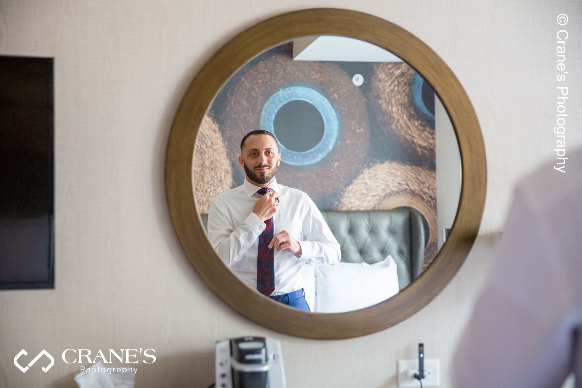 Groom is getting ready at Hotel Indigo for their wedding at Elements at Water Street