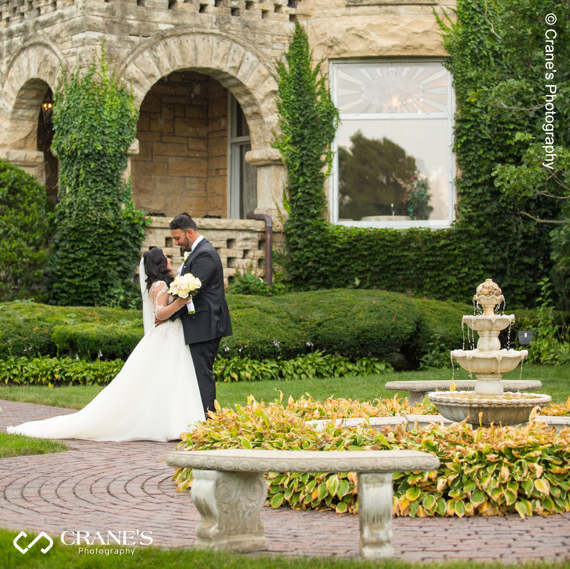 Haley Mansion wedding image taken during the summer next to the fountain on the front yard