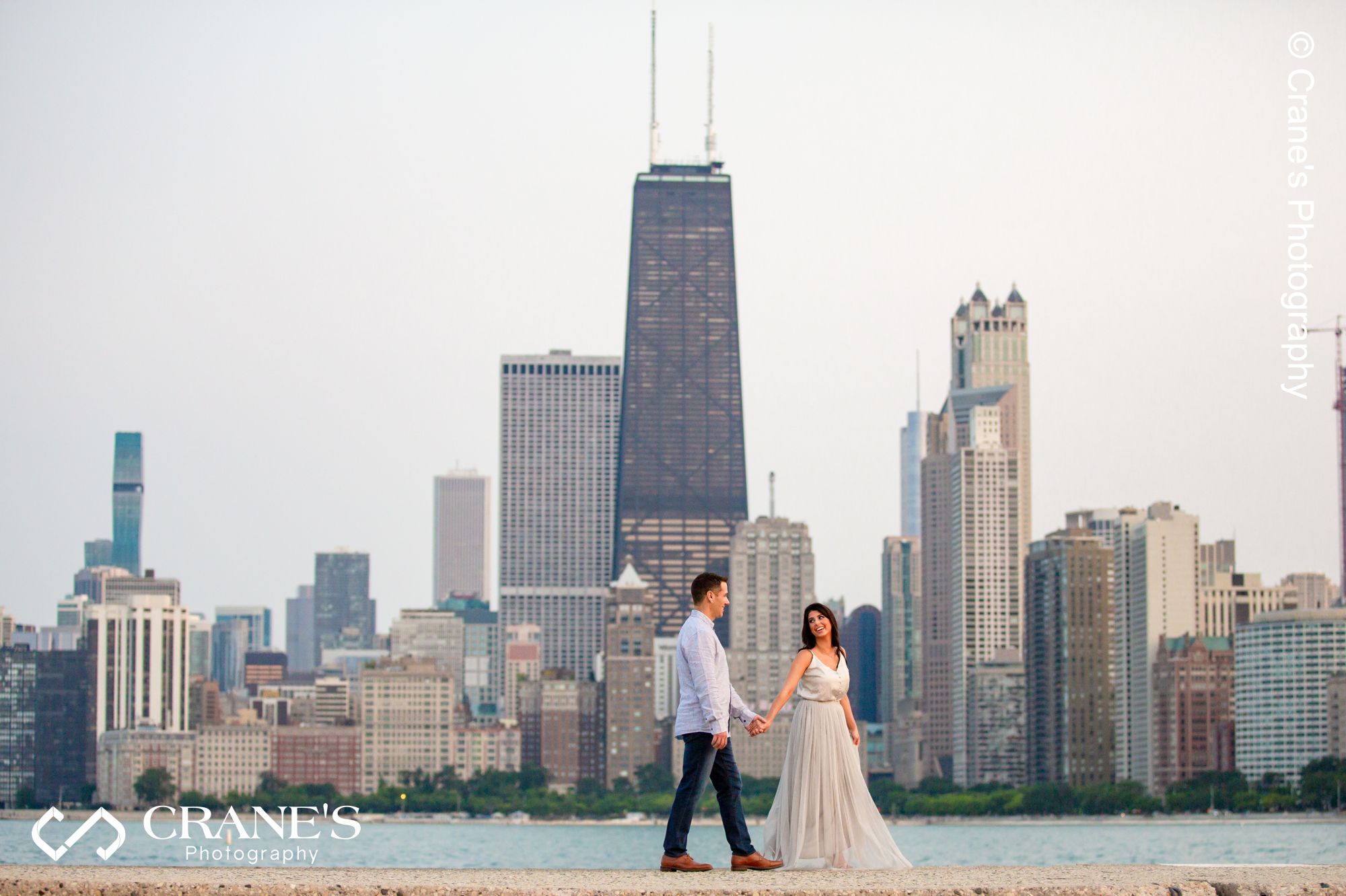 A beautiful sunset North Ave Beach engagement photo of a couple with downtown Chicago in the background