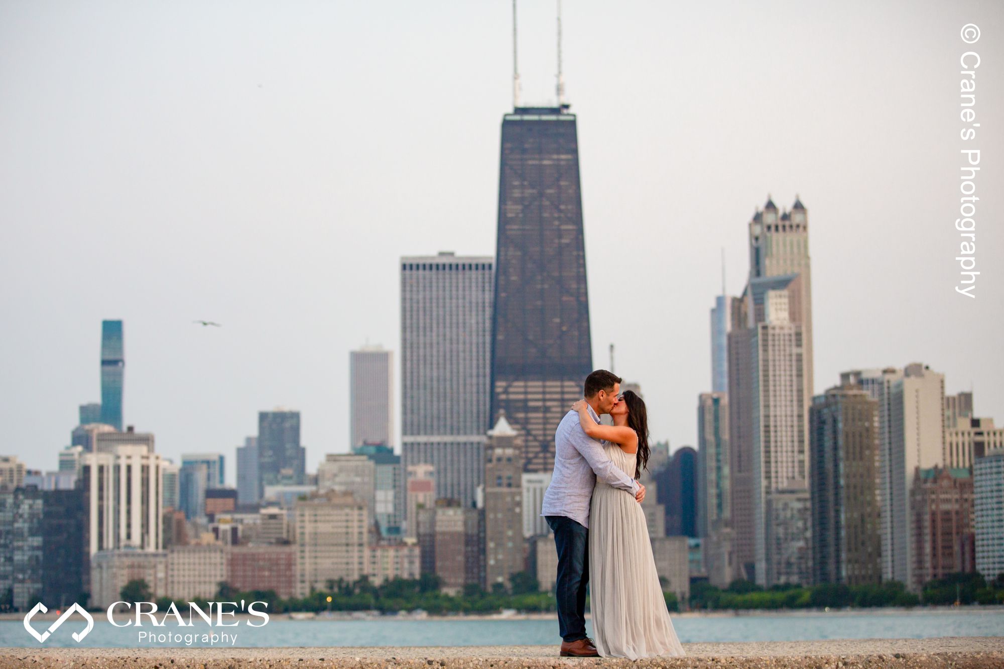 An iconic North Ave Beach engagement session with the Chicago skyline in the background