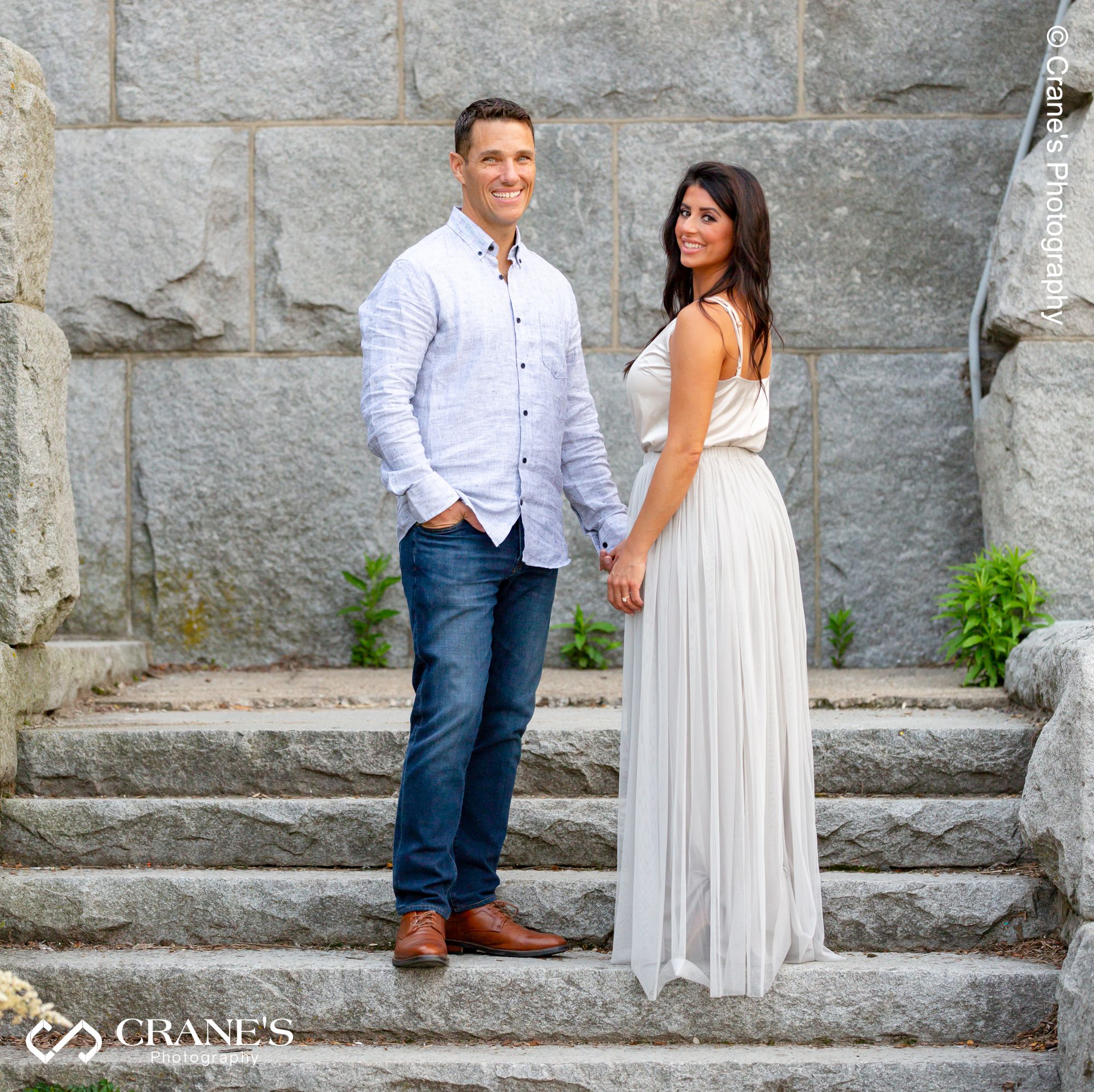 An engagement session photo of couple holding hands taken at the Ulysses S. Grant Monument stairs near North Ave Beach