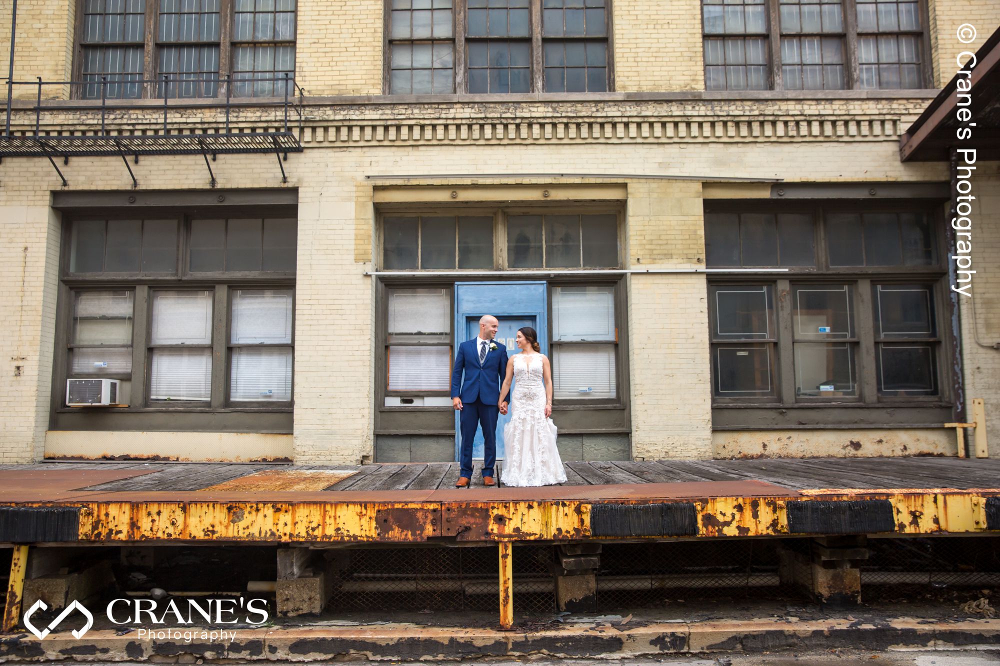 Industrial wedding photo taken on the dock at the alley in front of the Filament in Milwaukee