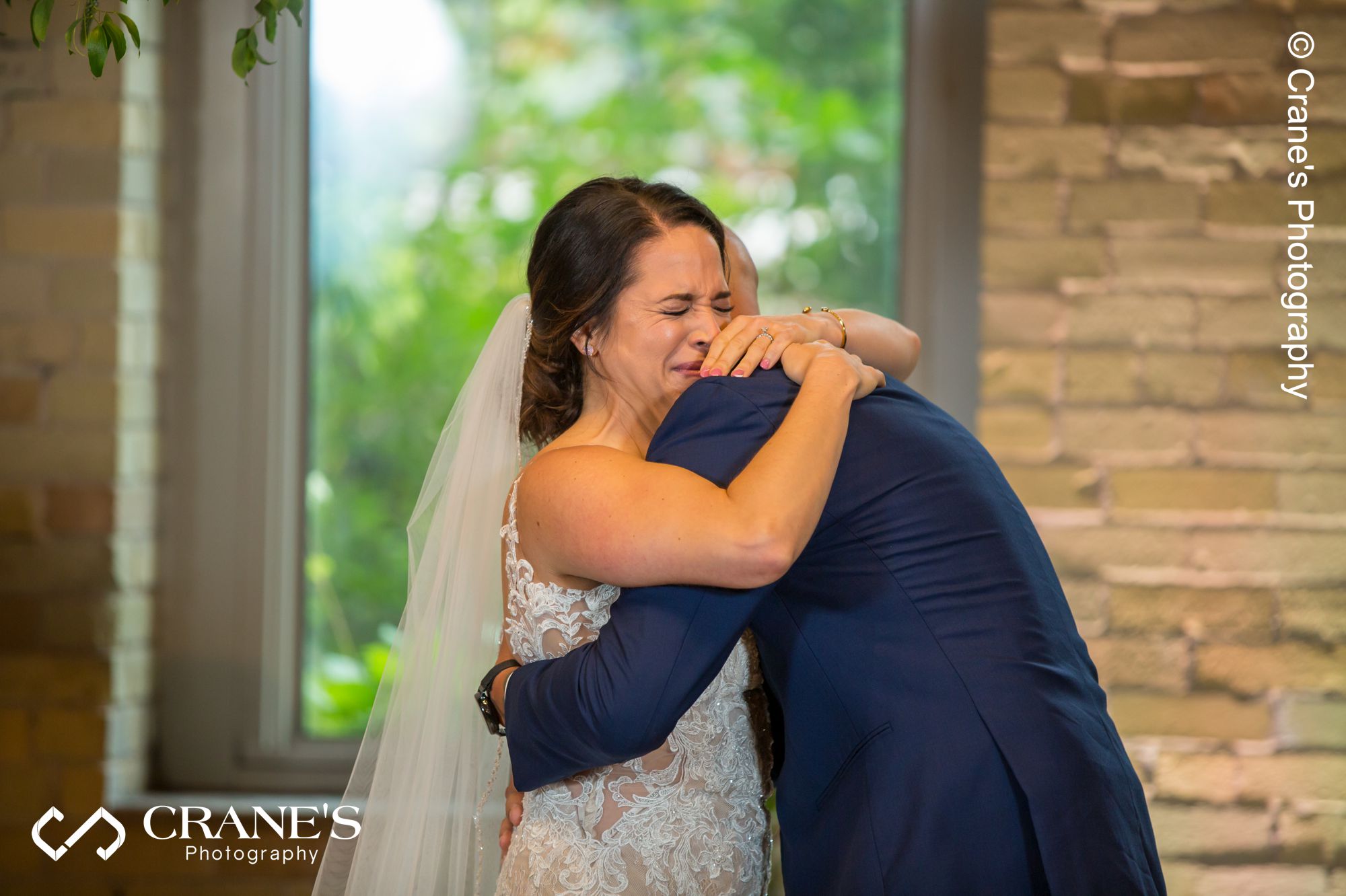 Bride gets emotional while his groom is hugging her right after the got married