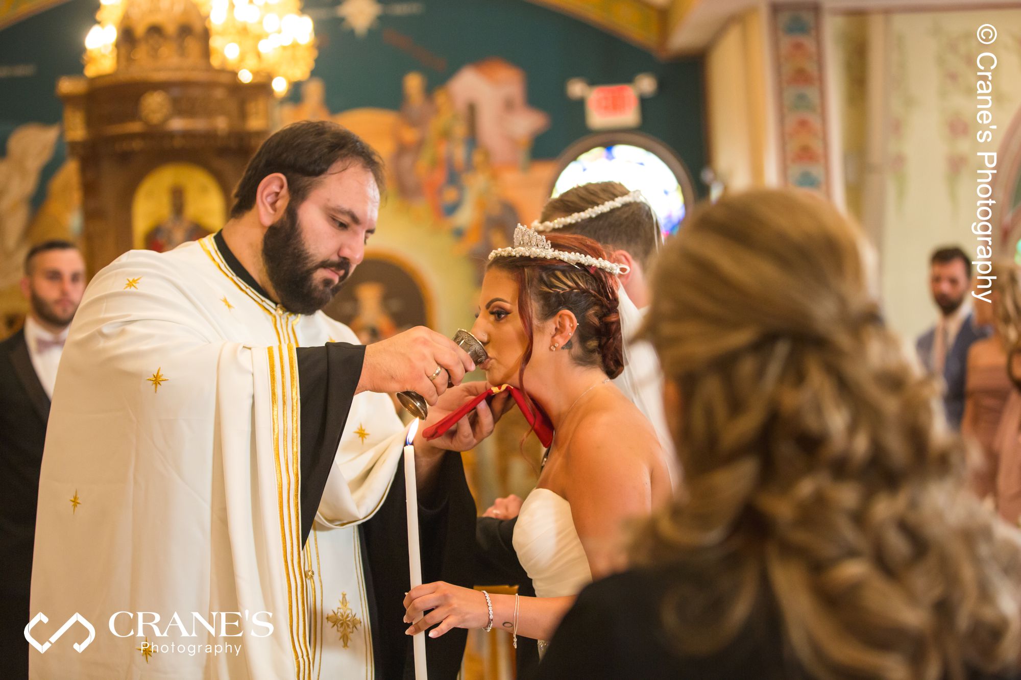 Greek bride sip from the common cup during an orthodox wedding ceremony at St. Nectarios in Palatine