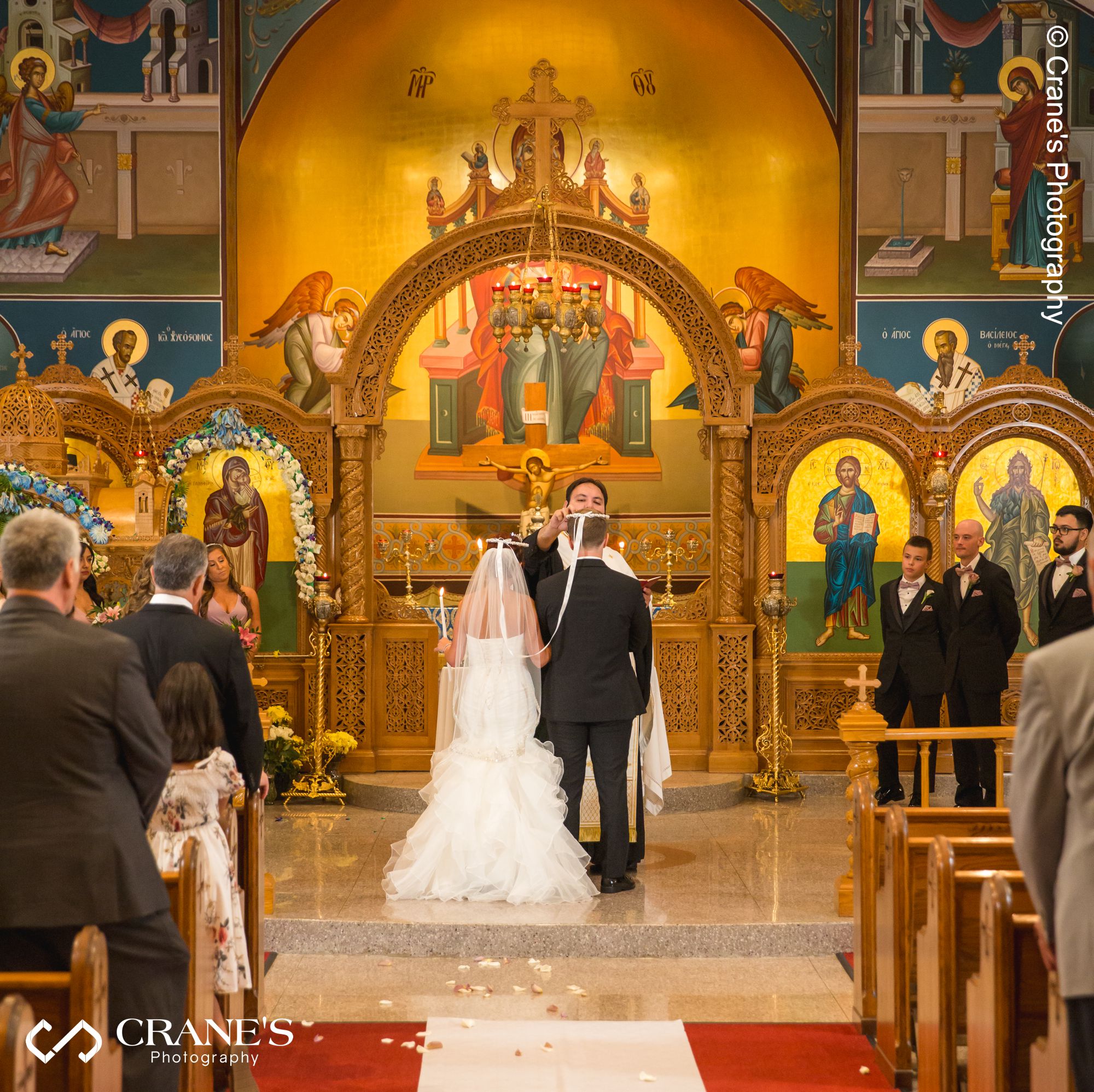 An orthodox wedding ritual "The crowning of the Bride and Groom" at the altar of St. Nectarios in Palatine, IL