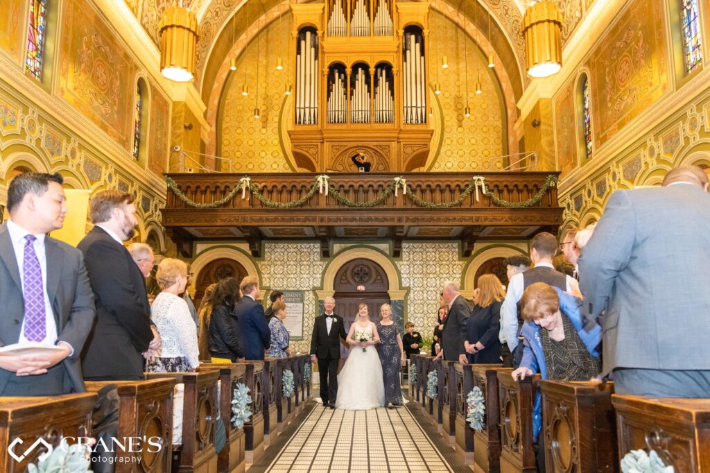 Bride walking down the aisle at St. Clement's Church in Lincoln Park in Chicago