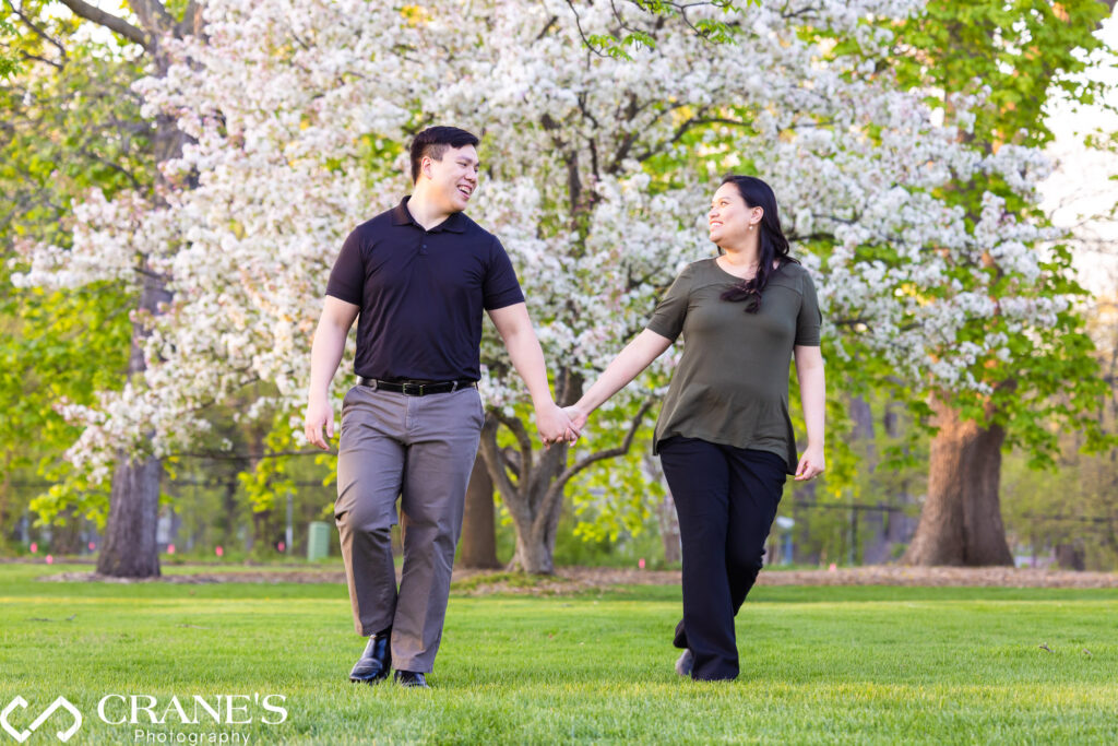 A Spring Engagement at Cantigny Park with white flowering tree in the background.