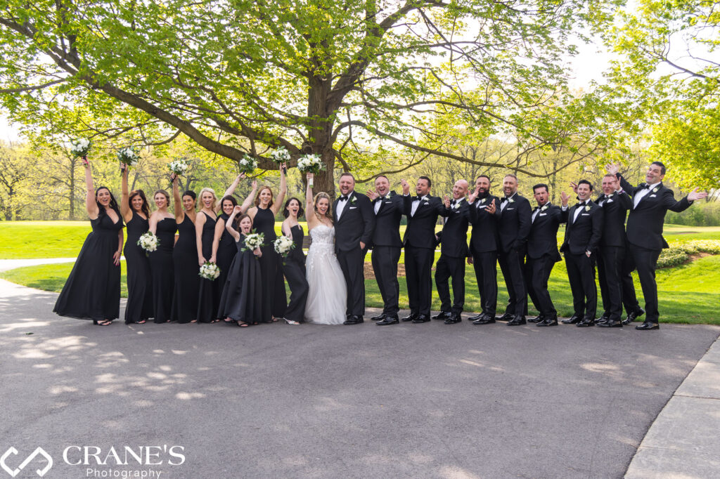 Large wedding party wearing black and white at Royal Melbourne Country Club.