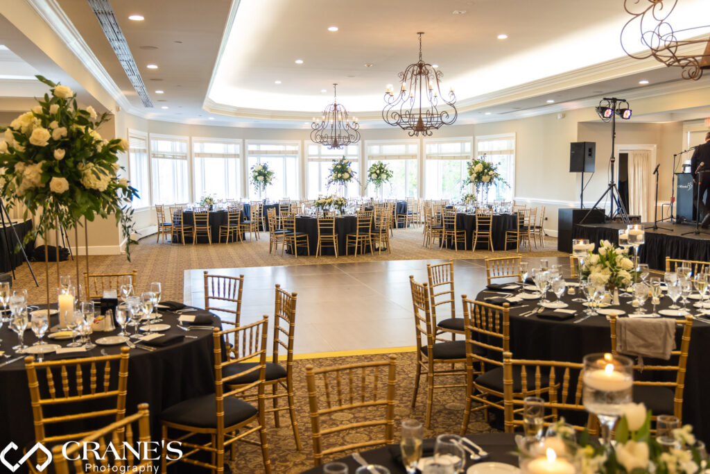 A wide-angle wedding reception photo of the ballroom at Royal Melbourne Country Club.