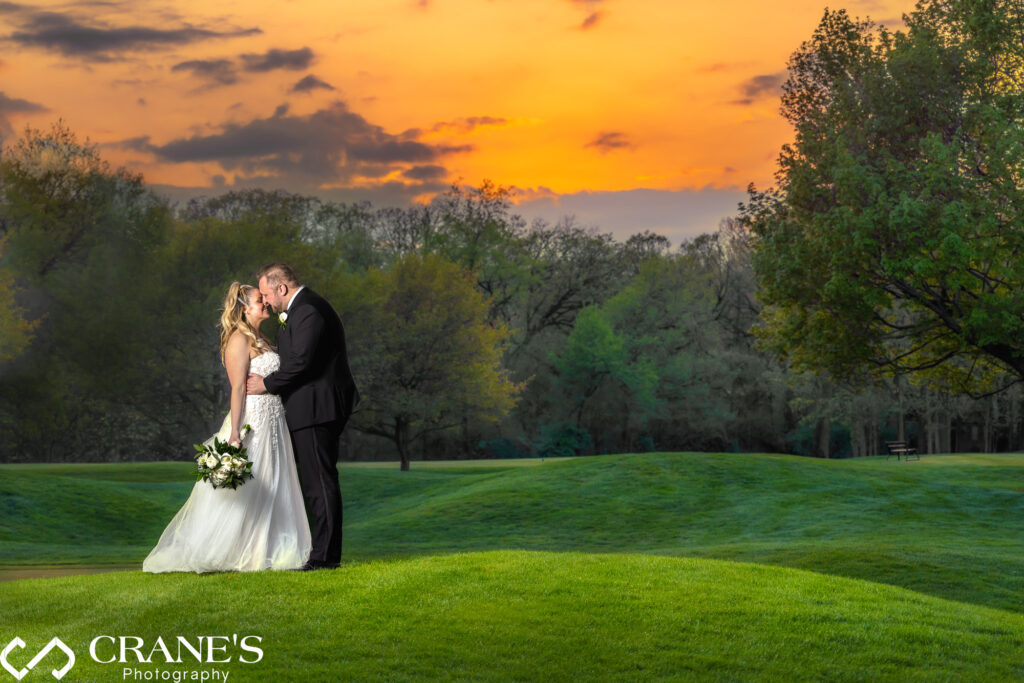 A sunset wedding photo taken at the 18th Green at Royal Melbourne Country Club in Long Grove, Illinois.
