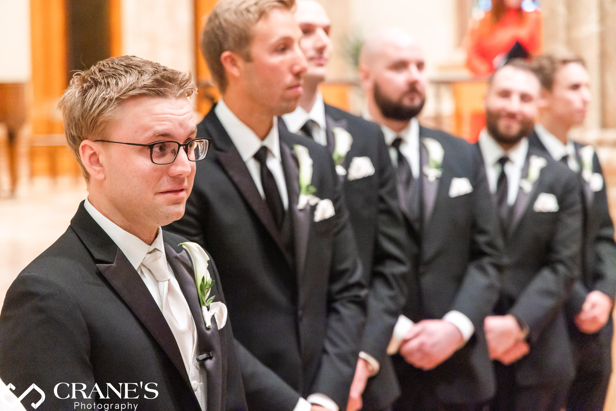 Grooms reaction when he see his bride walking down the aisle at Holy Name Cathedral.