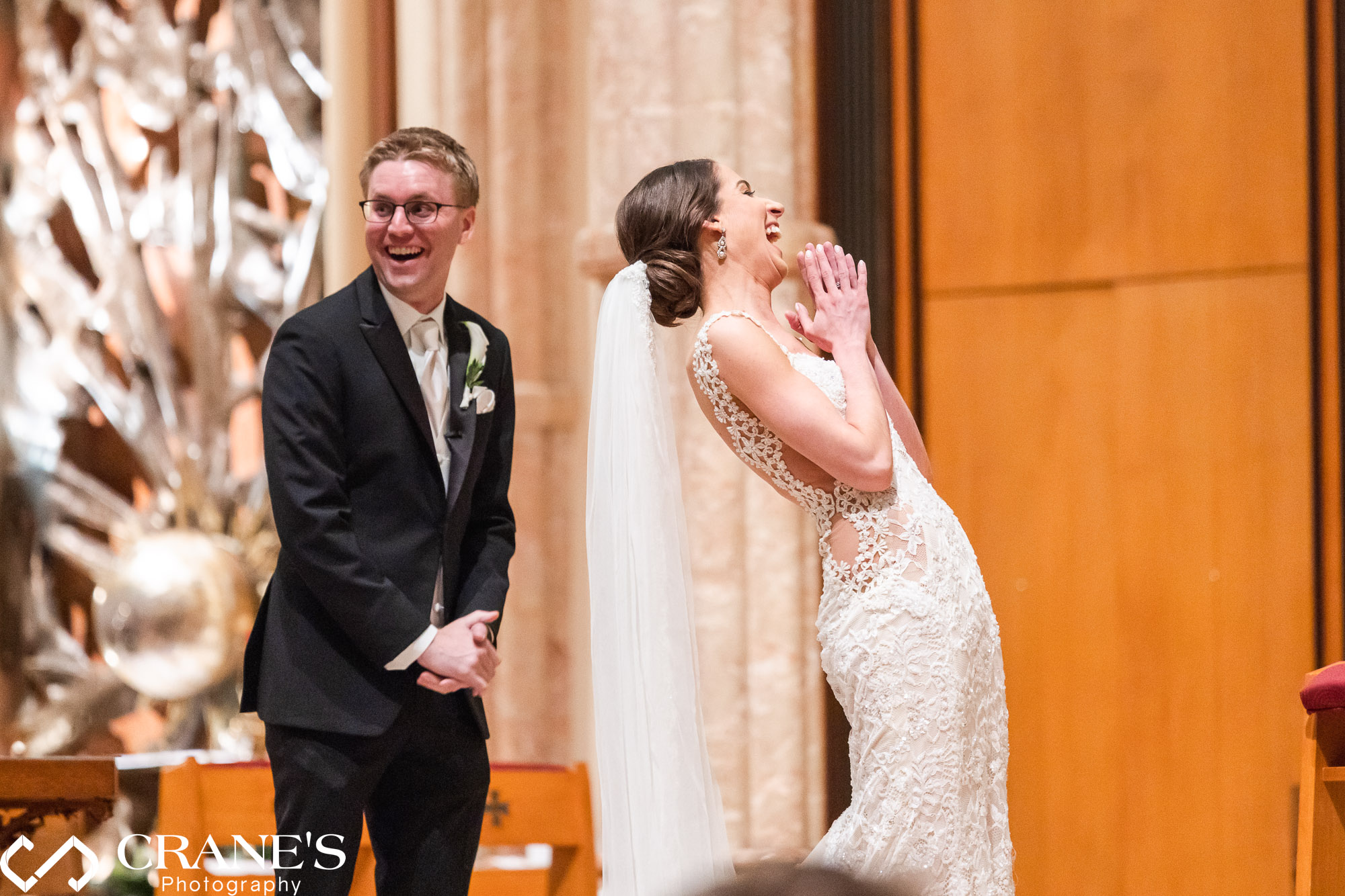 A candid moment between a bride and groom during their wedding ceremony at Holy Name Cathedral.