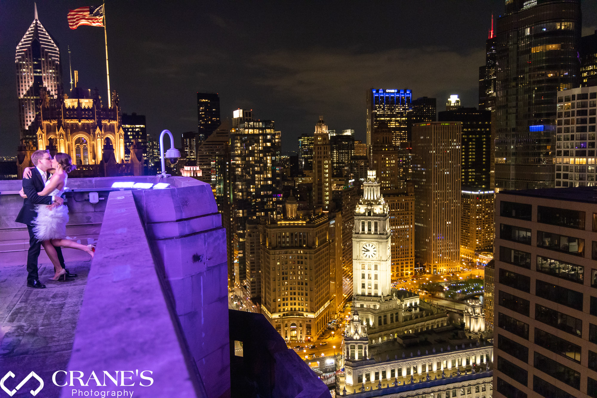 A wedding photo taken on the rooftop at InterContinental with The Wrigley Building in the background.