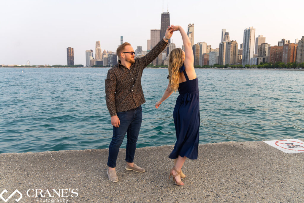 Byron and Lisabeth are dancing during their engagement session in Lincoln Park in Chicago.