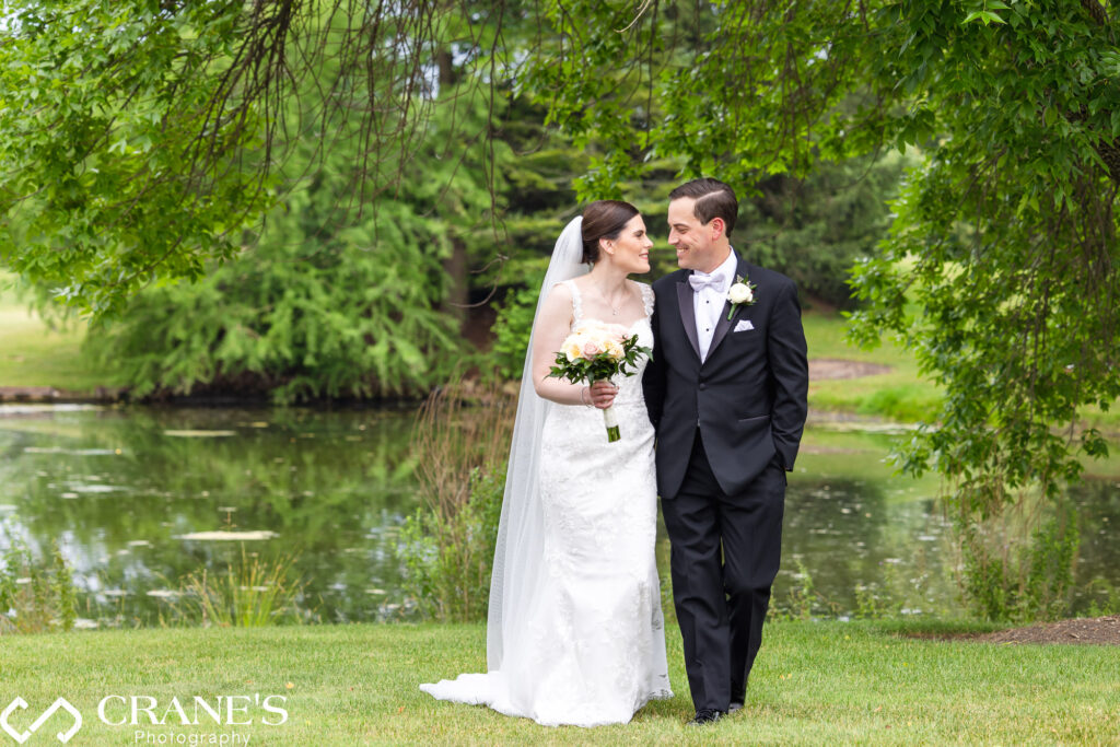 Groom smiles looking at his bride on their summer wedding day at Royal Melbourne in Long Grove, IL.