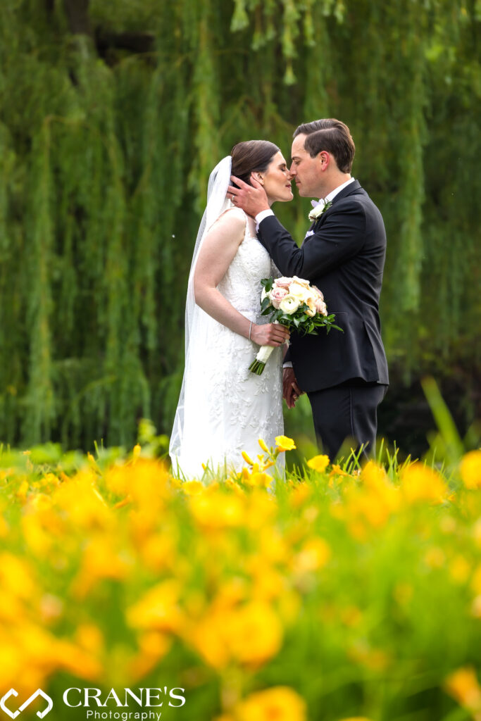 Wedding portrait with summer flowers and a willow tree in the background at Royal Melbourne Country Club.