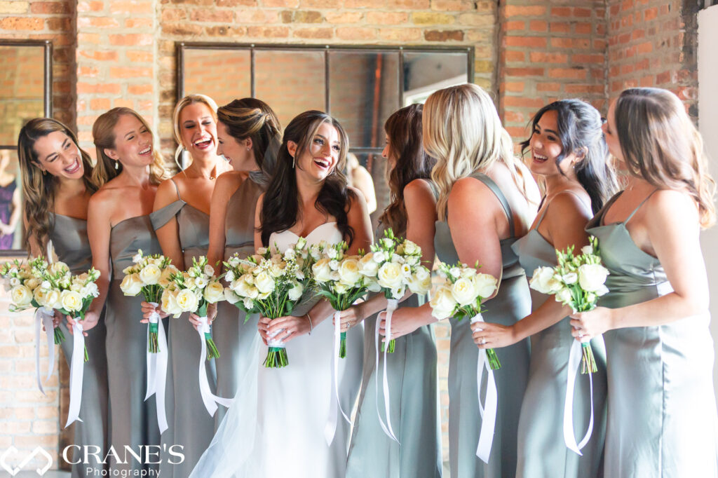 Bridesmaids are having fun during their photography session at the Fairlie venue in Chicago. 