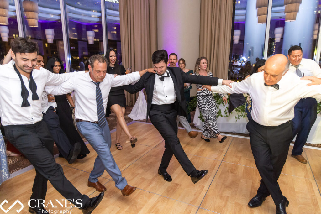 Lisabeth and Byron celebrate with Greek dancing at the wedding reception at Trump Tower.