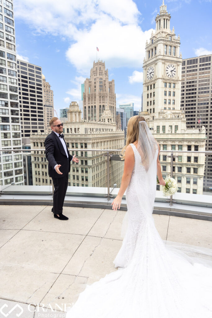 A first look moment between a bride and groom on the terrance on the 16th floor at Trump Tower in Chicago.