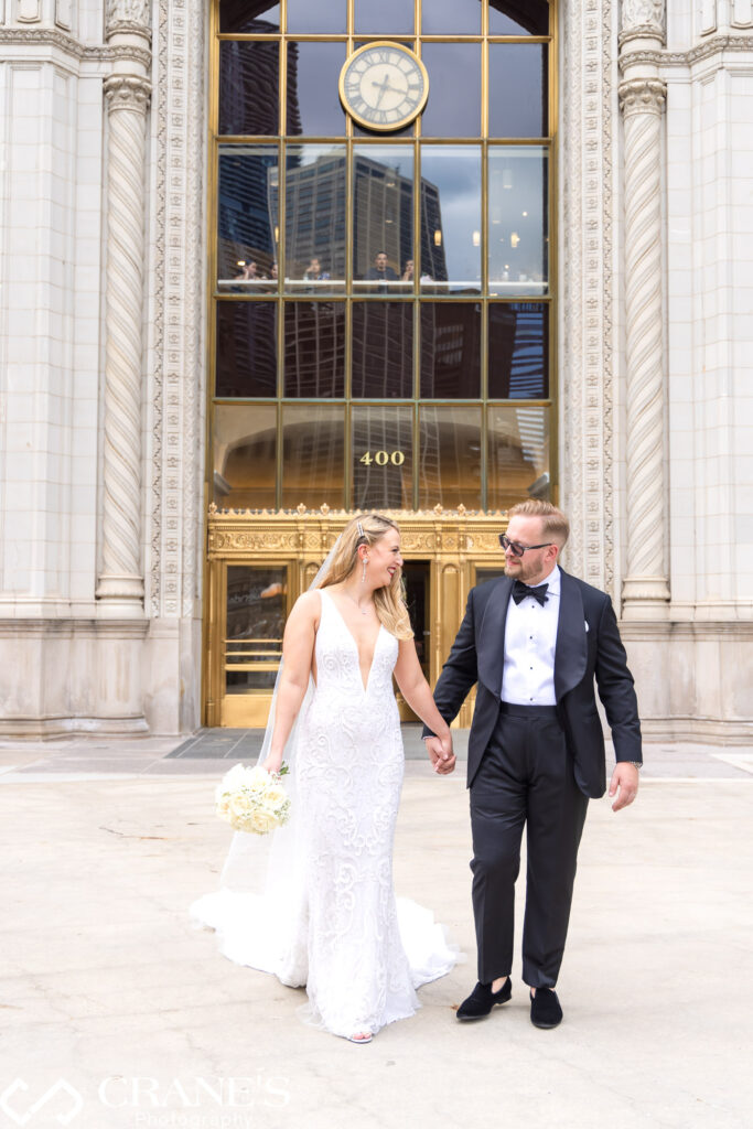 Lisabeth and Byron on their wedding day in front of Wrigley Building that is close to Trump Tower in Chicago.