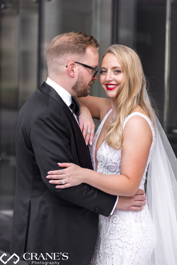 Fancy looking bride and groom take wedding photos outside Trump Tower.