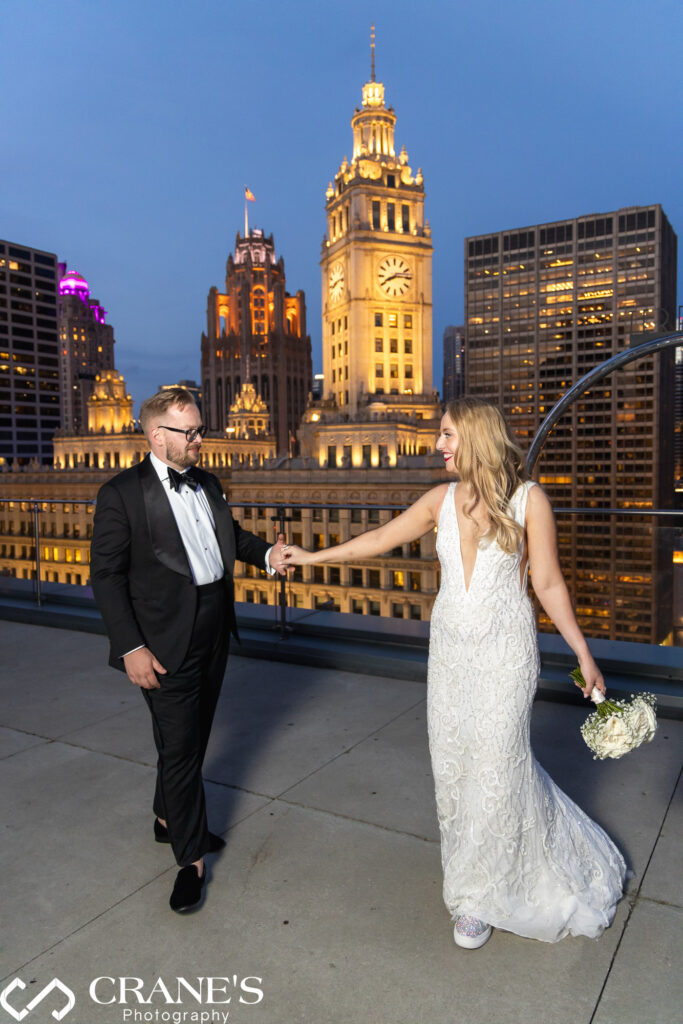 A night wedding photo taken at Trump Tower  with the iconic Wrigley Building commanding attention in the backdrop.