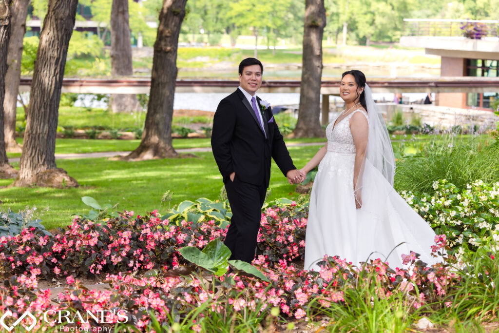 Summer wedding at Hyatt Lodge with  colorful flower beds and tranquil lake.