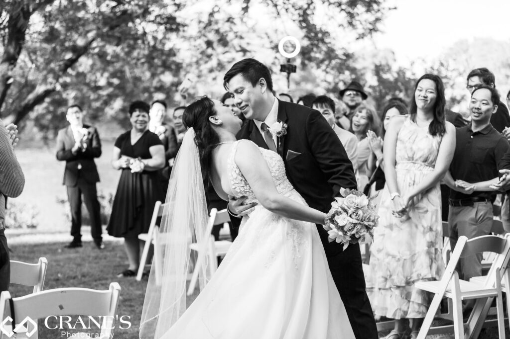 Birde and groom first kiss at their outdoor wedding ceremony at Hyatt Lodge.