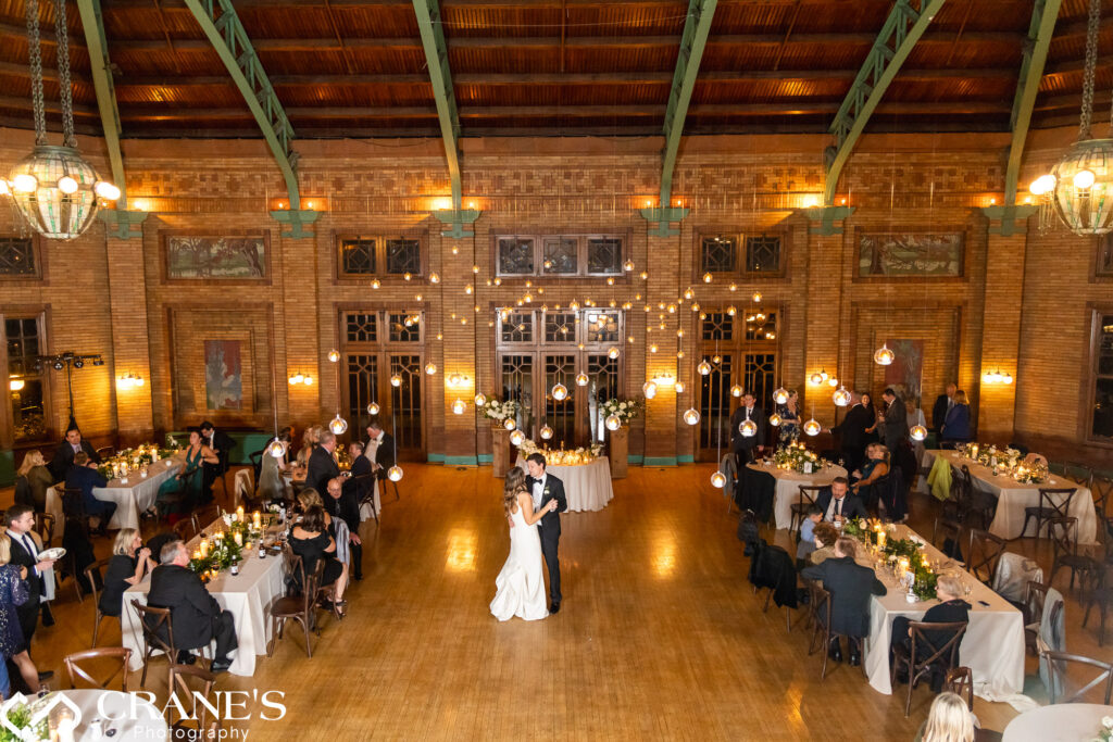 The bride and groom share their first dance as a married couple during their wedding reception at the Great Hall at Cafe Brauer.