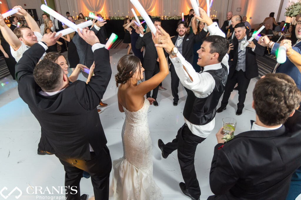 The bride and groom, along with their wedding guests, take over the dance floor at Loews Hotel in Rosemont.