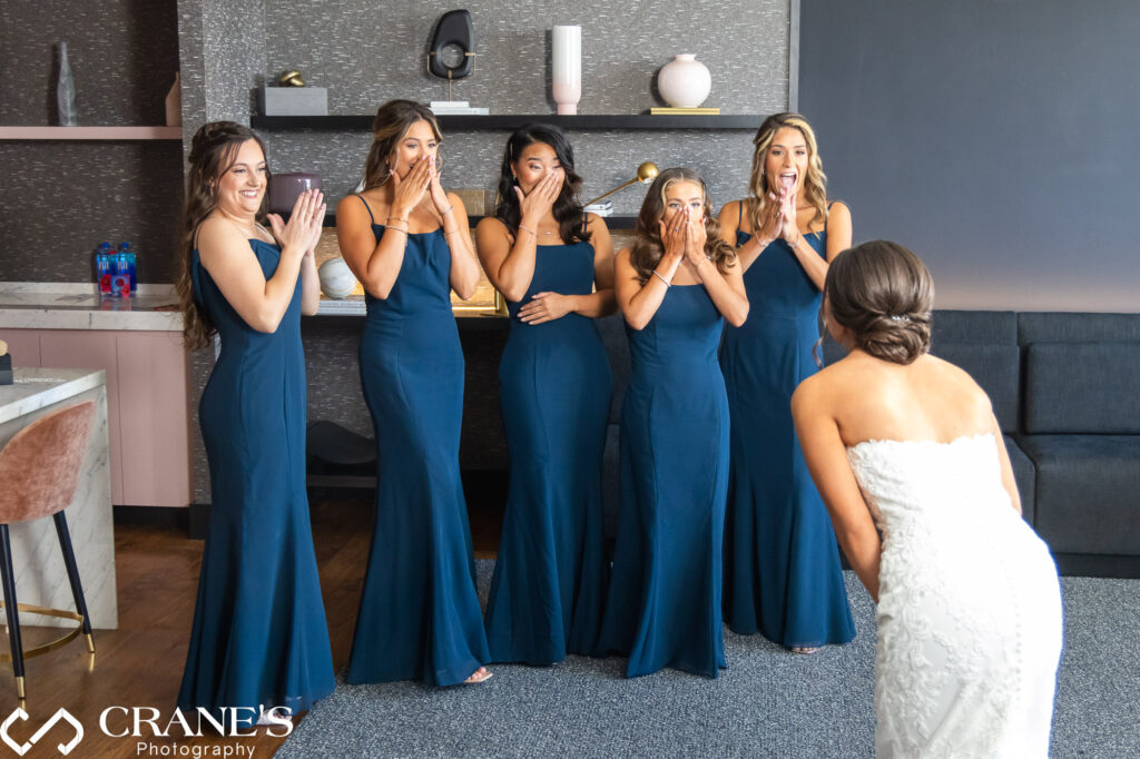 The moment the bridesmaids catch their first glimpse of the bride on her wedding day at Loews in Rosemont.